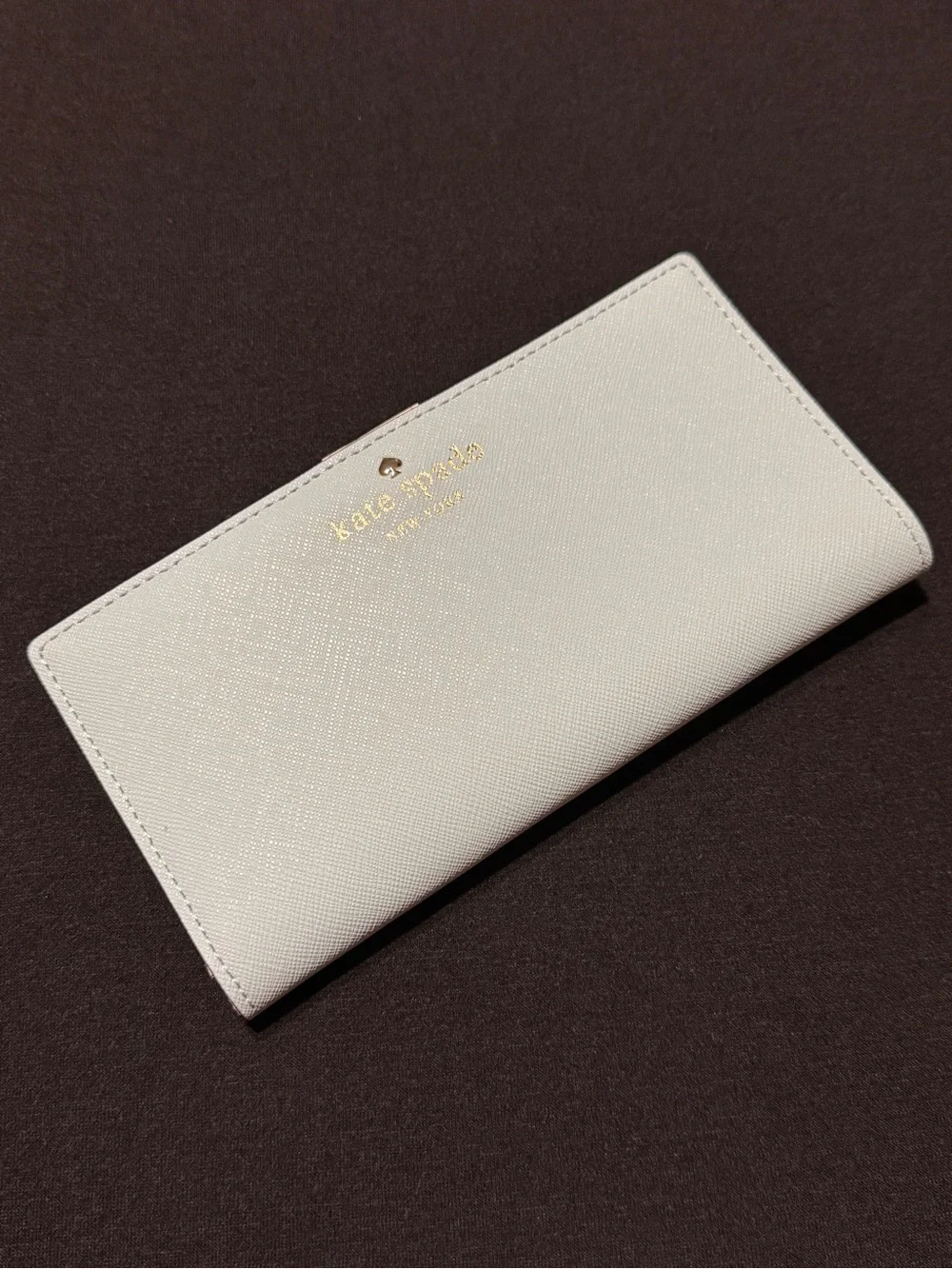 NWOT Kate Spade light blue wallet with gold logo